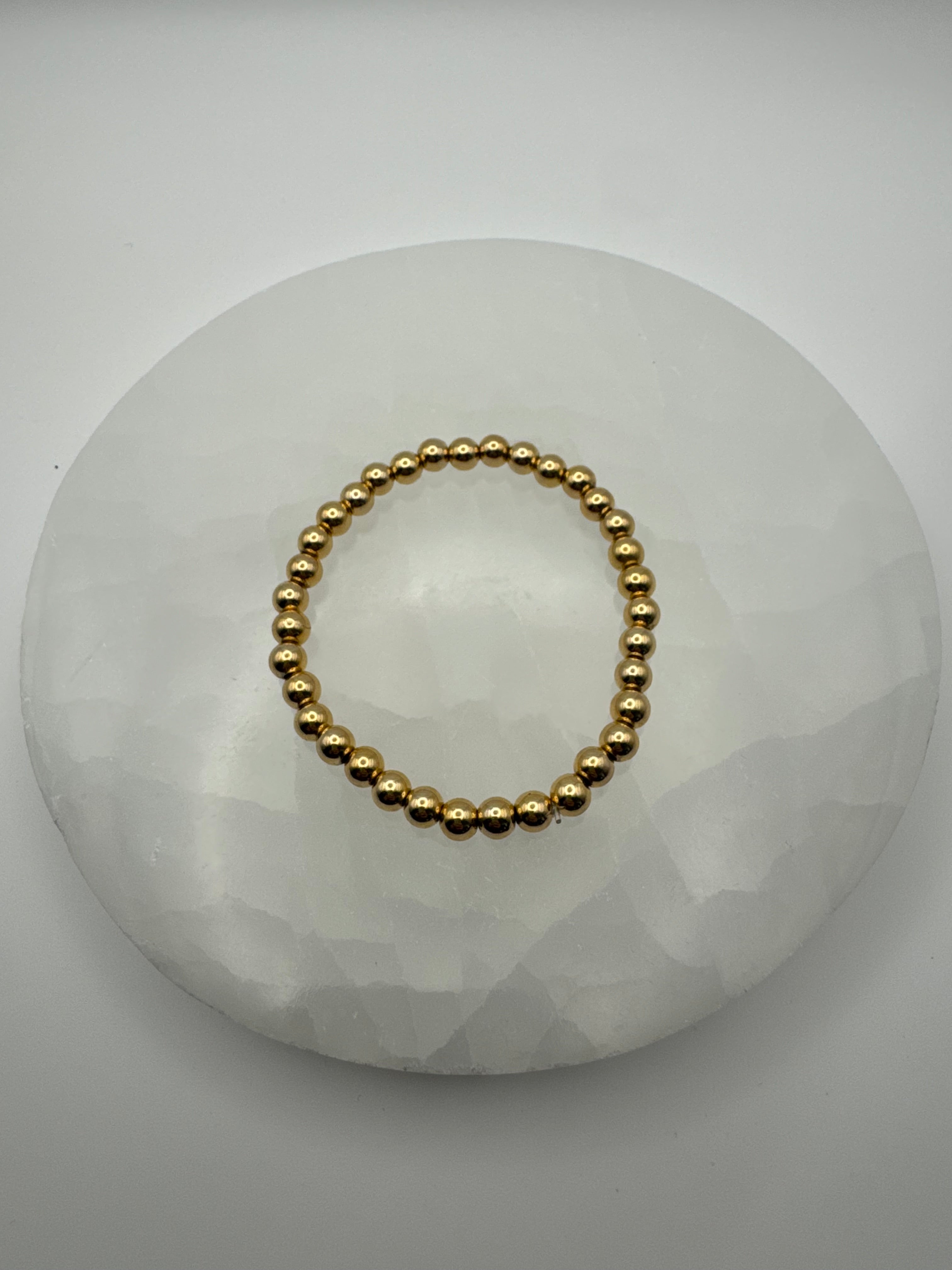 4mm 18k gold filled stretch beaded bracelet on stone surface