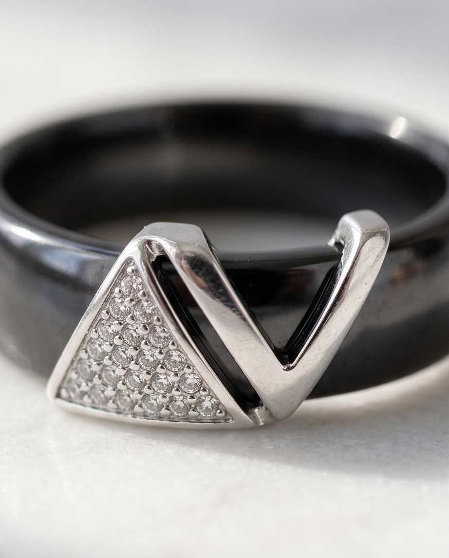 Close-up detail of Avant silver plated geometric V pavé CZ topper on black ceramic band, Stacked by Jayneebell