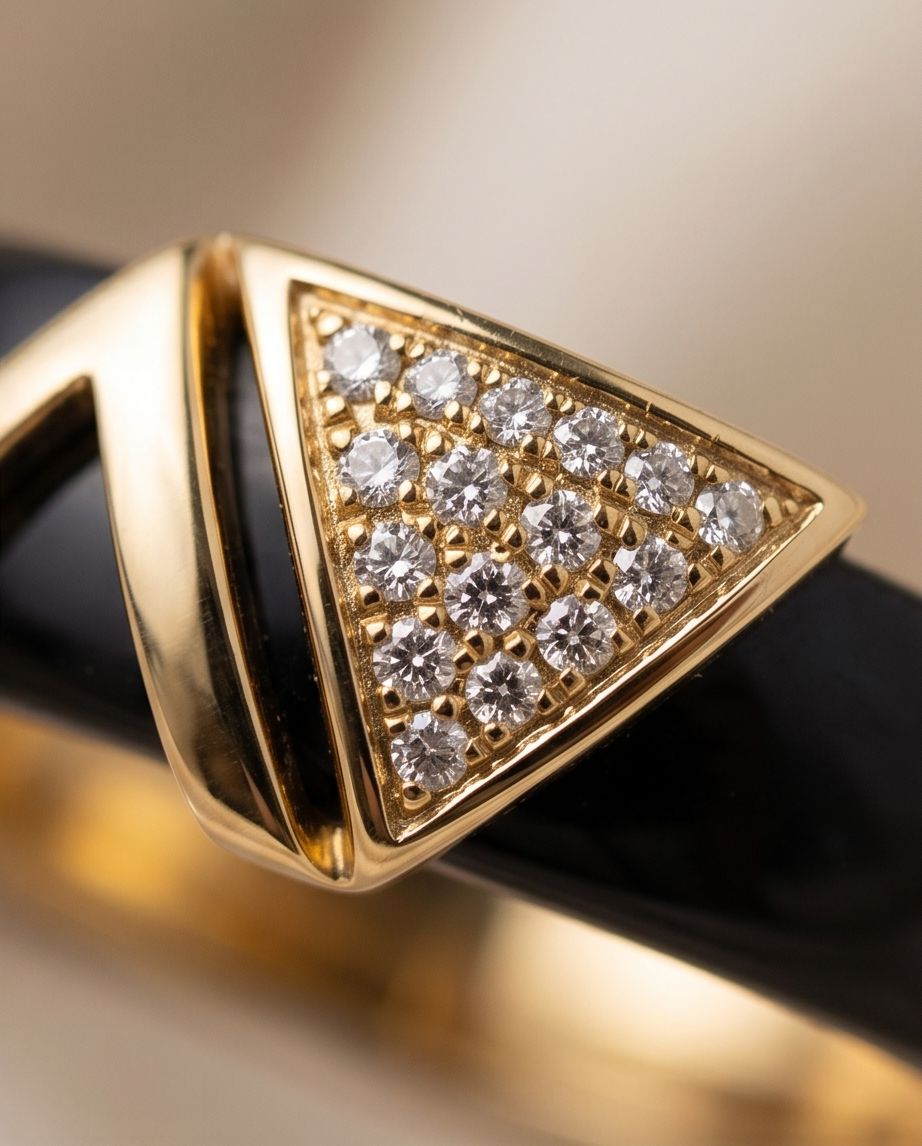 Close-up detail of Avant gold plated geometric V pavé CZ topper on black ceramic band, Stacked by Jayneebell