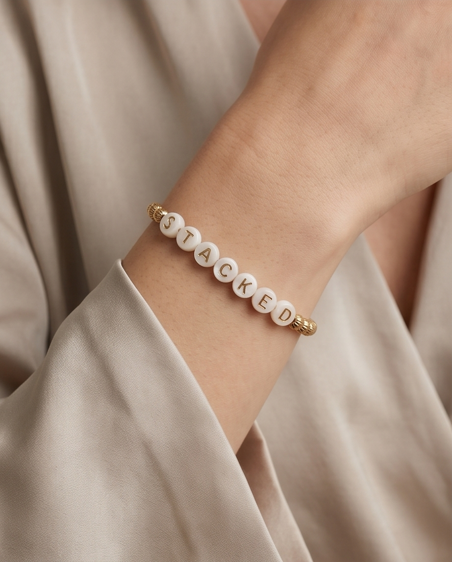 Custom beaded bracelet spelling STACKED worn on wrist — Just Sayin&