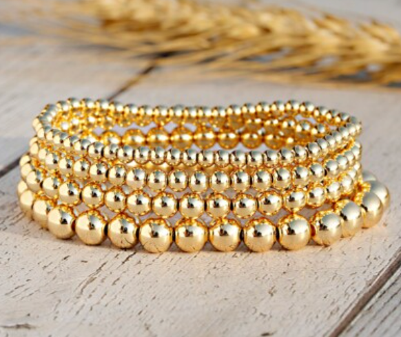 Gold beaded bracelets from the STACKED Founders Collection