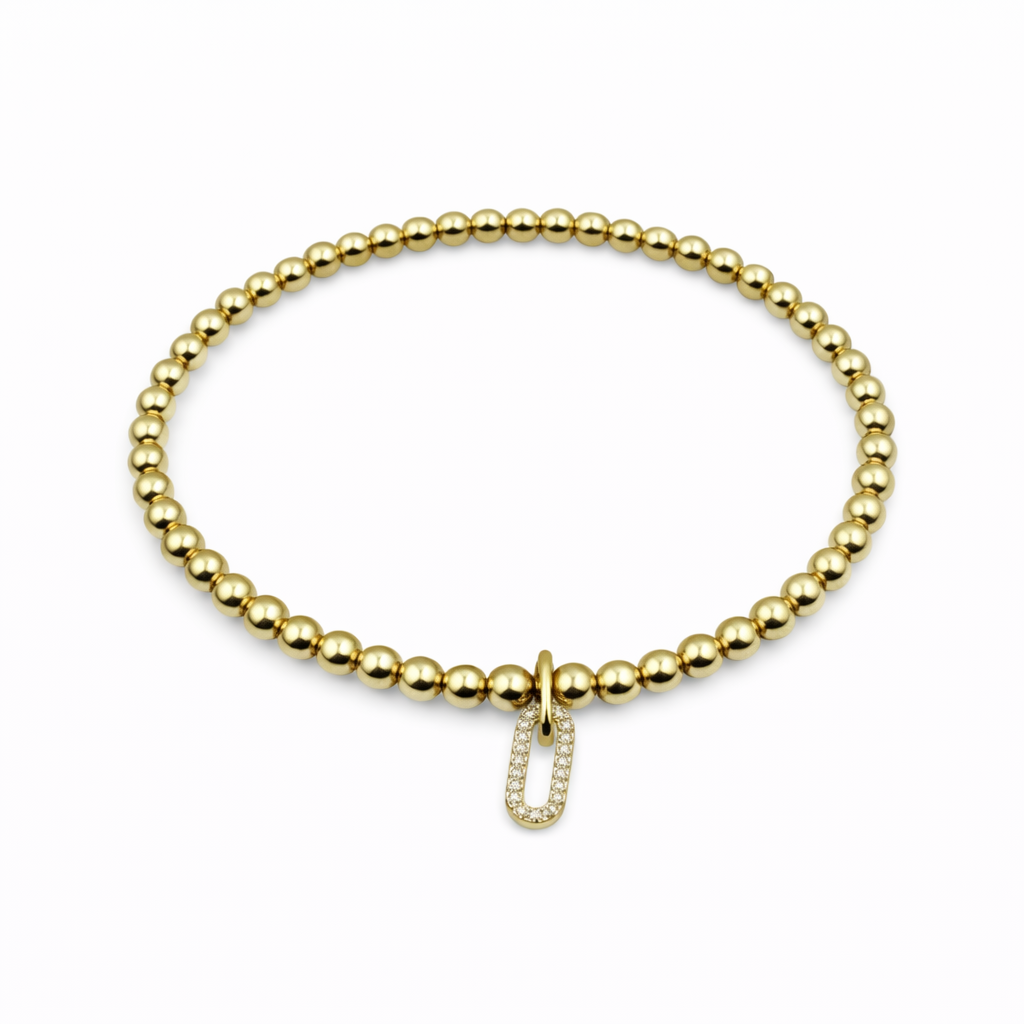 Gold beaded bracelet with a clasp on a white background
