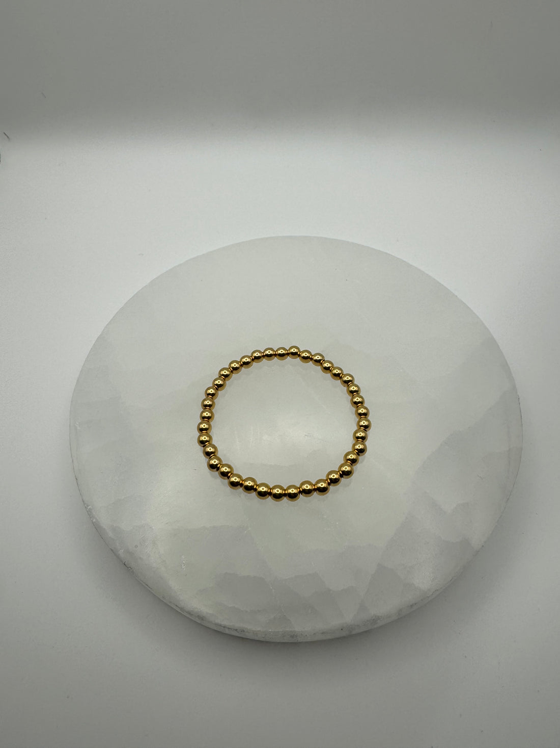 4mm 18k gold filled stretch beaded bracelet on stone surface