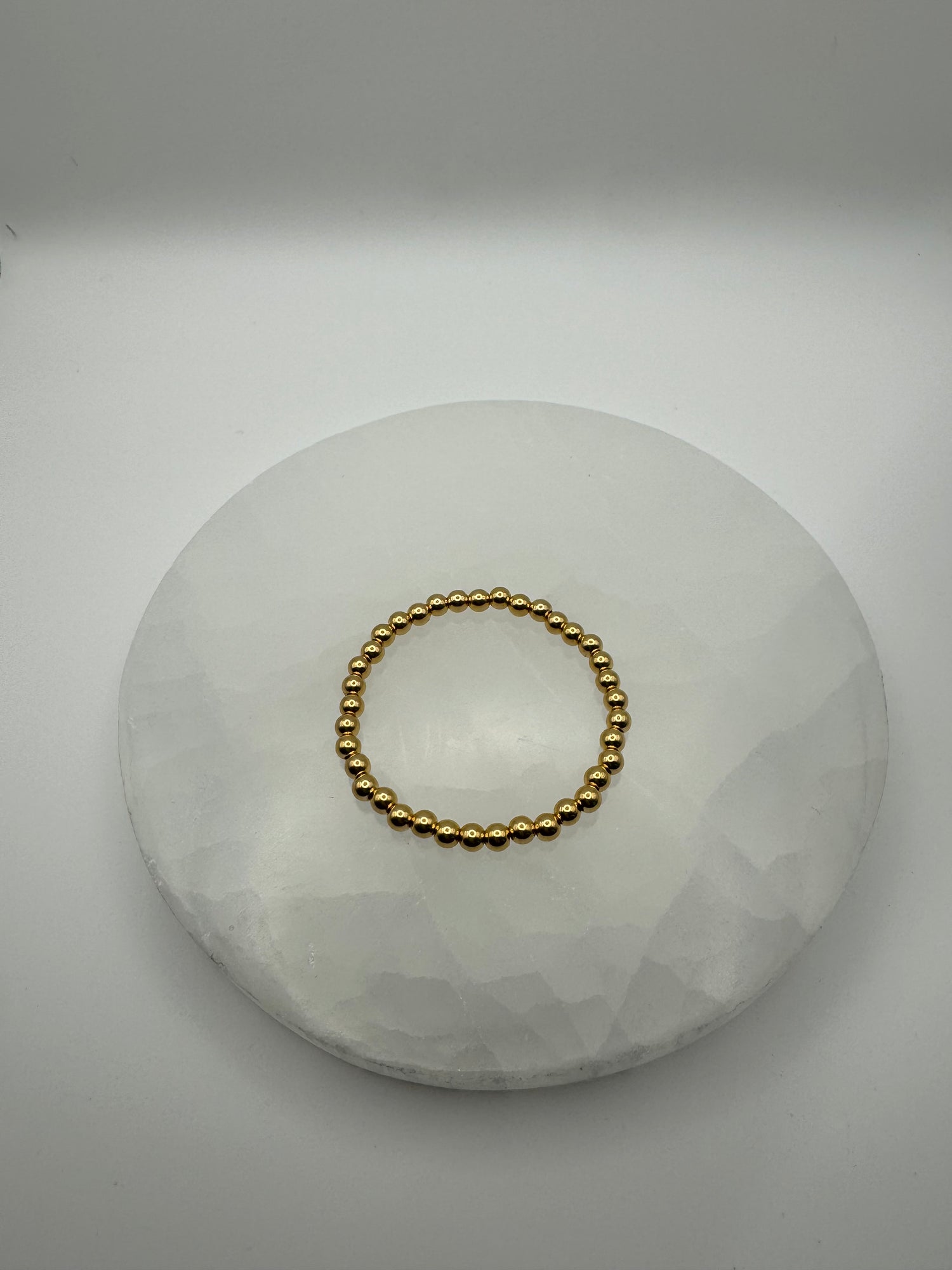 4mm 18k gold filled stretch beaded bracelet on stone surface