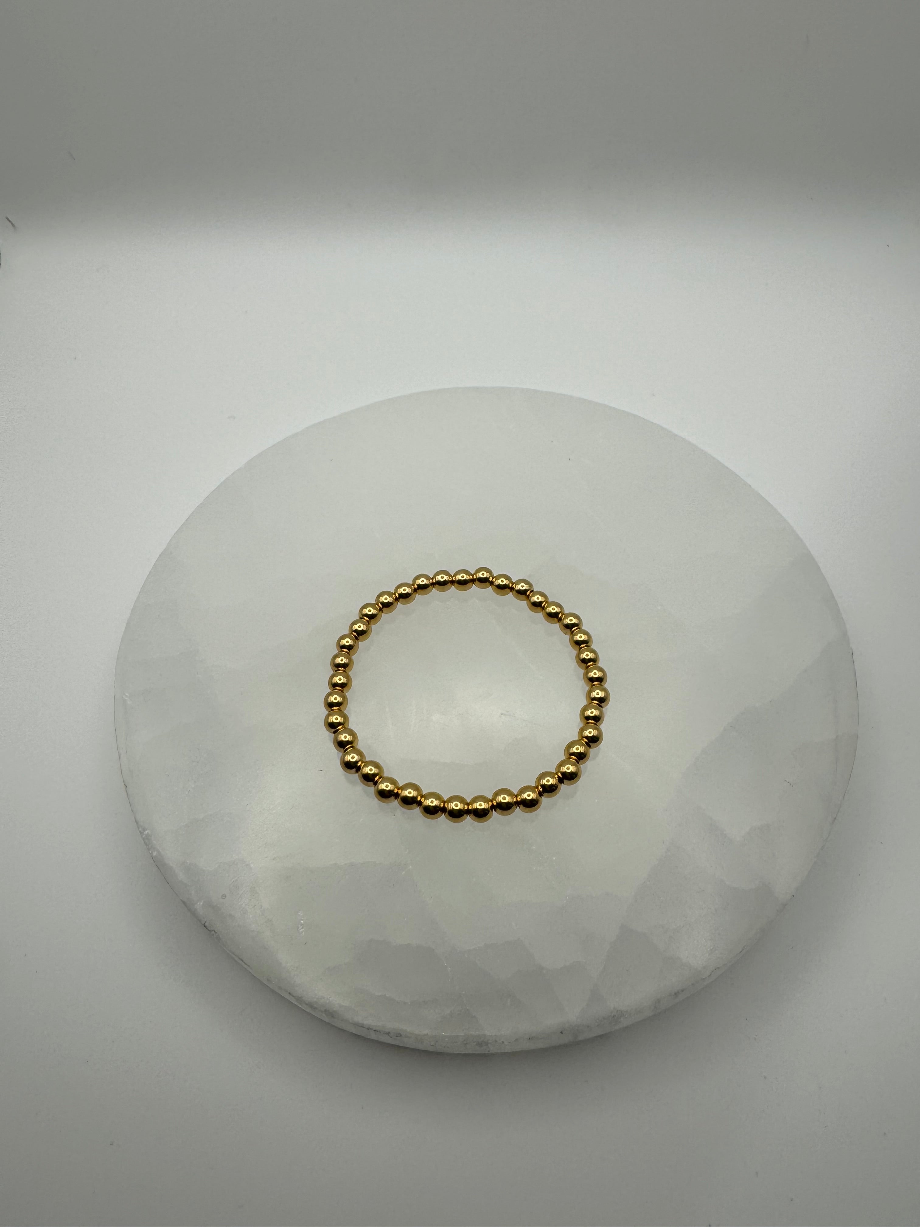 4mm 18k gold filled stretch beaded bracelet on stone surface