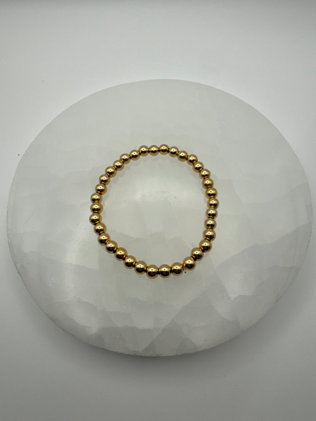 4mm 18k gold filled stretch beaded bracelet on stone surface