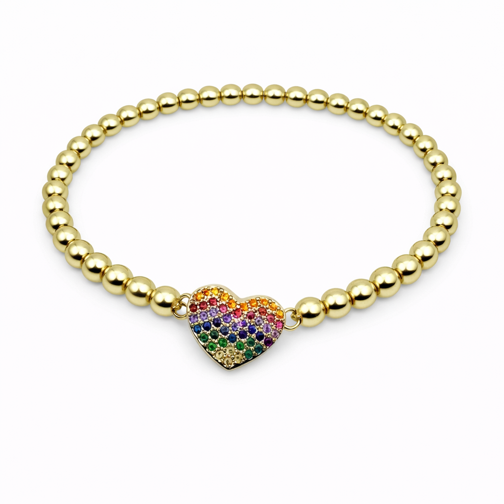 Gold beaded bracelet with a colorful heart charm on a white background