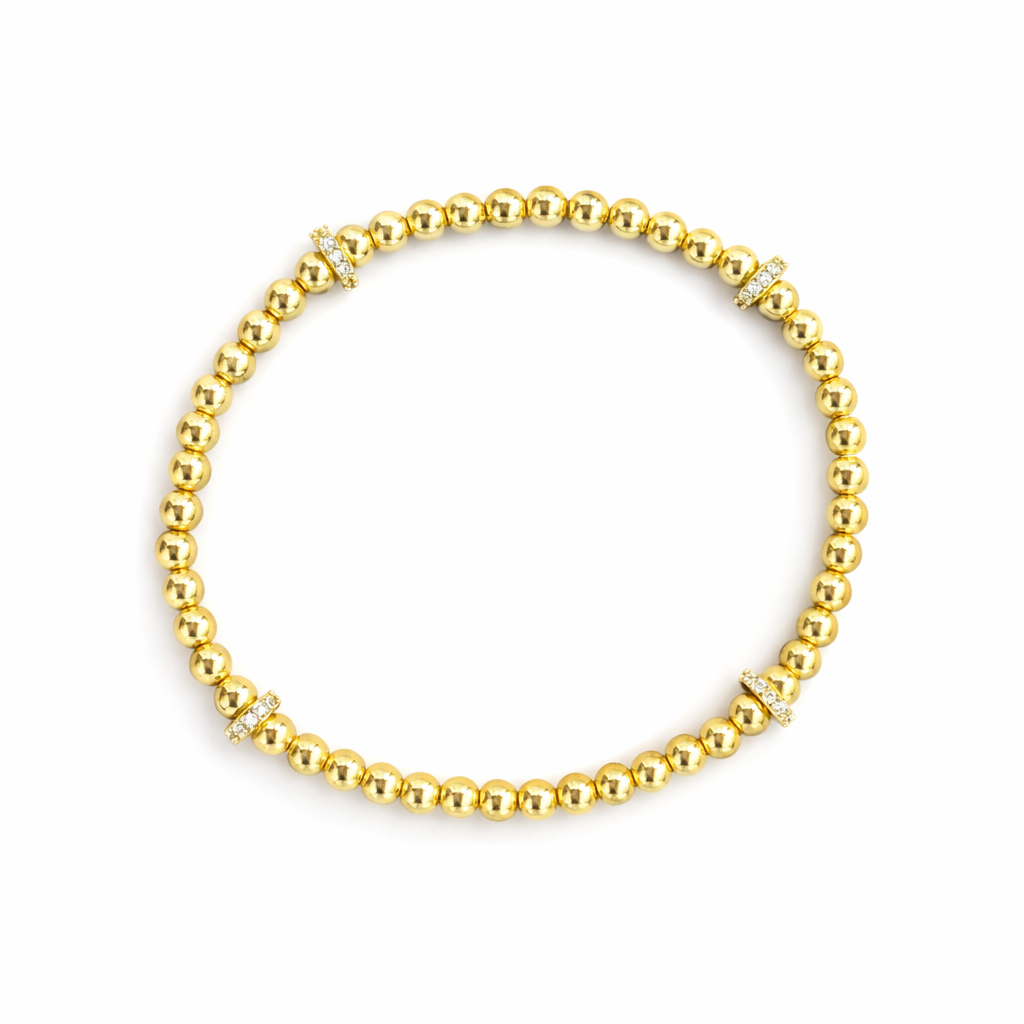 Gold beaded bracelet on a white background