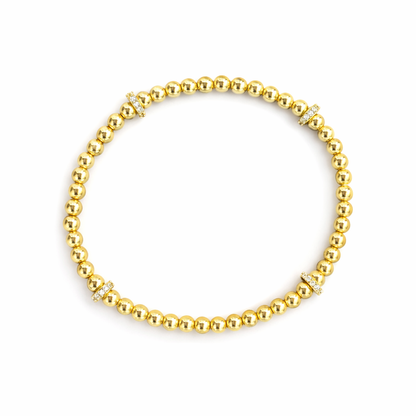 Gold beaded bracelet on a white background
