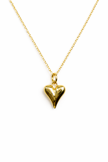 Gold heart-shaped pendant on a chain against a white background