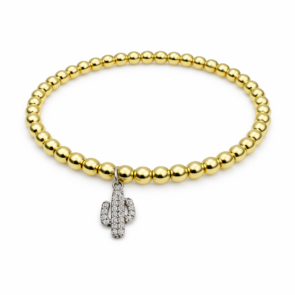 gold beaded bracelet with cactus charm on white background