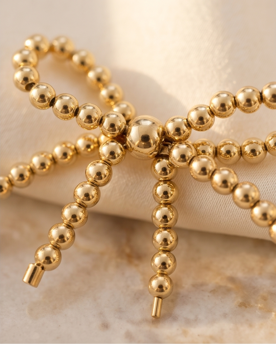 Close up of gold filled bead bow focal on bracelet — The Coquette by Stacked by Jayneebell