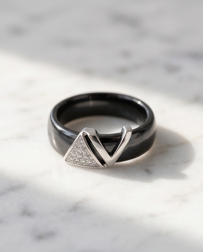 Avant black ceramic ring with silver plated geometric V pavé CZ topper on marble, Stacked by Jayneebell