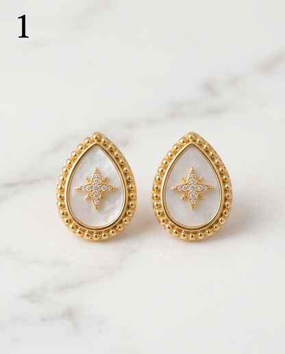 True North mother of pearl gold milgrain teardrop stud earrings with pavé CZ north star on marble, Stacked by Jayneebell