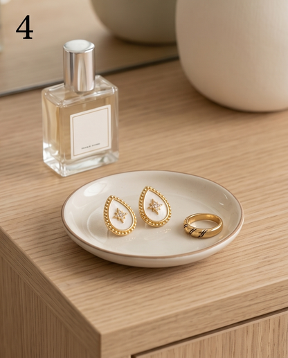True North mother of pearl stud earrings on ceramic jewelry dish with vanity styling, Stacked by Jayneebell