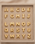 All 26 18k gold filled bubble letters A through Z displayed in suede tray — Make It Mine by Stacked by Jayneebell