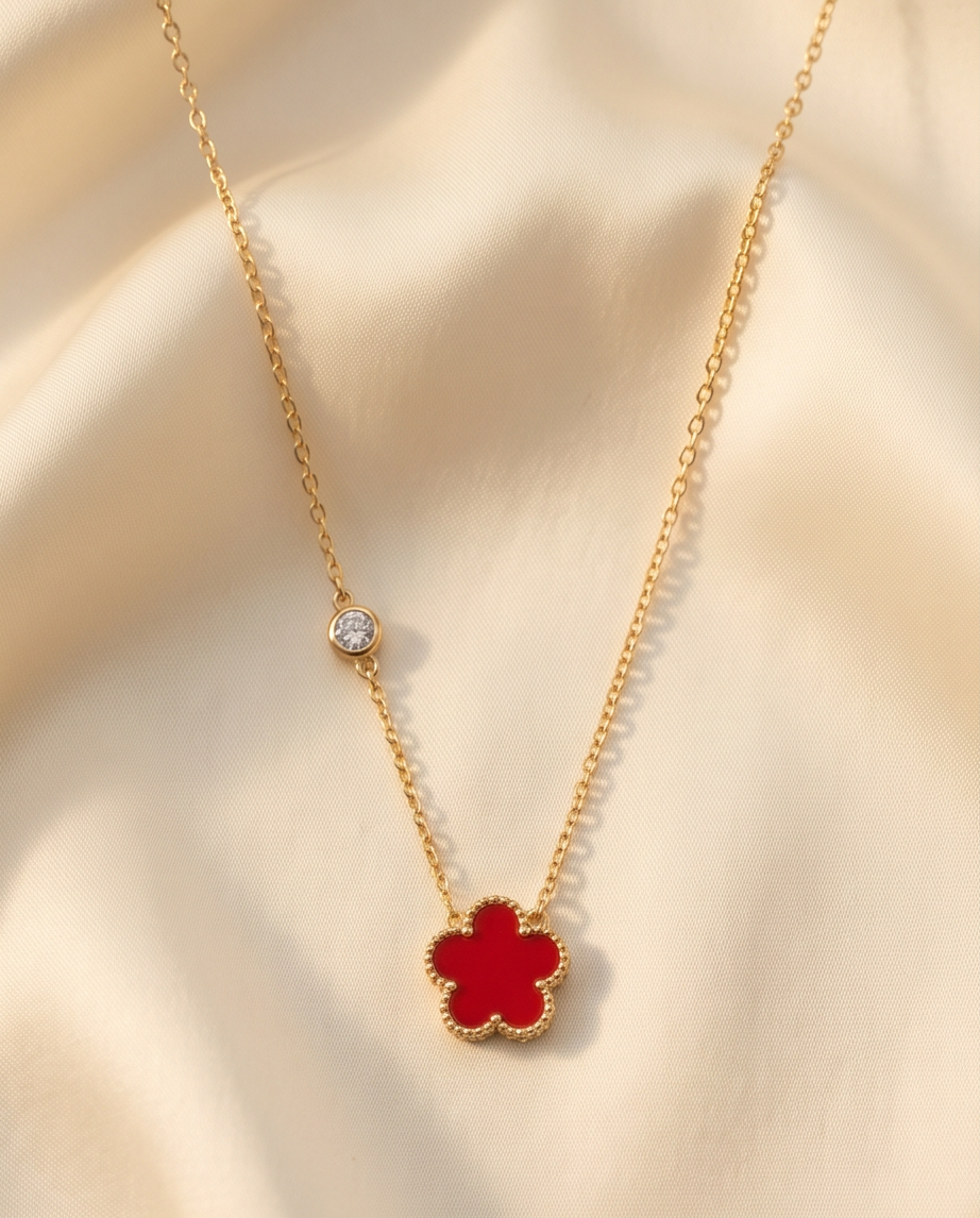Très Clove rouge red enamel flower pendant gold PVD necklace on cream fabric, Stacked by Jayneebell
