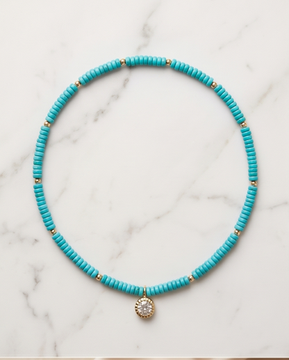 16 inch turquoise disc bead stretch necklace with CZ solitaire gold filled pendant on marble — Stacked by Jayneebell
