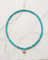 16 inch turquoise disc bead stretch necklace with CZ solitaire gold filled pendant on marble — Stacked by Jayneebell