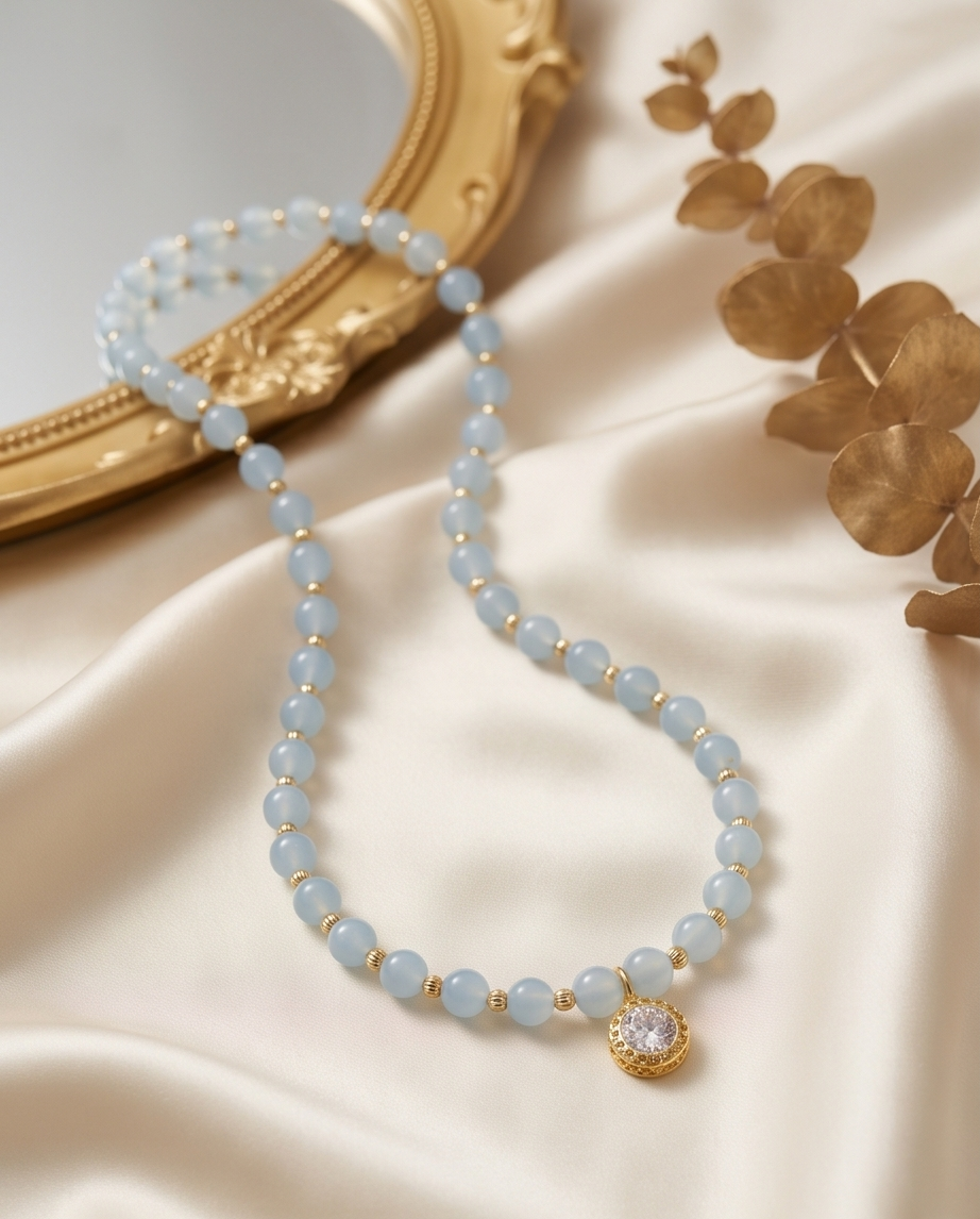16 inch aquamarine and gold filled stretch beaded necklace with CZ solitaire pendant on silk background — Stacked by Jayneebell