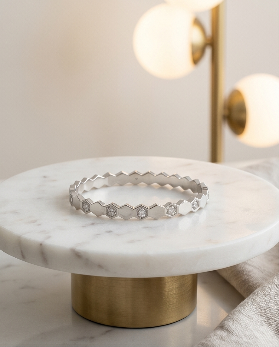 The Hive Bangle silver honeycomb hexagon CZ bangle on marble pedestal, Stacked by Jayneebell
