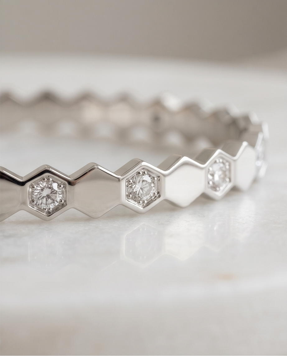Close-up detail of The Hive Bangle silver honeycomb hexagon CZ solitaire stations, Stacked by Jayneebell