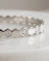 Close-up detail of The Hive Bangle silver honeycomb hexagon CZ solitaire stations, Stacked by Jayneebell