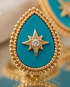 Gold and turquoise teardrop-shaped pendant with star design