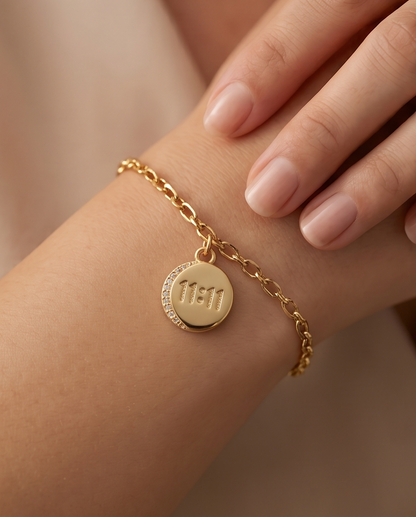 Gold filled 11:11 coin charm worn on gold chain bracelet on wrist — Stacked by Jayneebell
