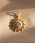 Gold filled evil eye sunburst convertible charm with cubic zirconia center stone on linen background — Stacked by Jayneebell