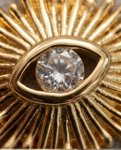 Close up of round brilliant cubic zirconia bezel set in gold filled evil eye charm — Stacked by Jayneebell