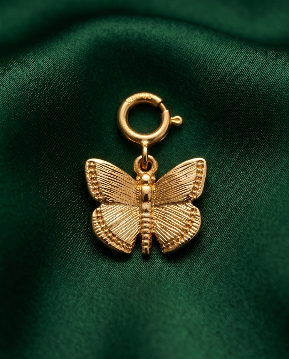 14k gold filled butterfly charm with textured wings and spring clasp on green velvet — Becoming by Stacked by Jayneebell