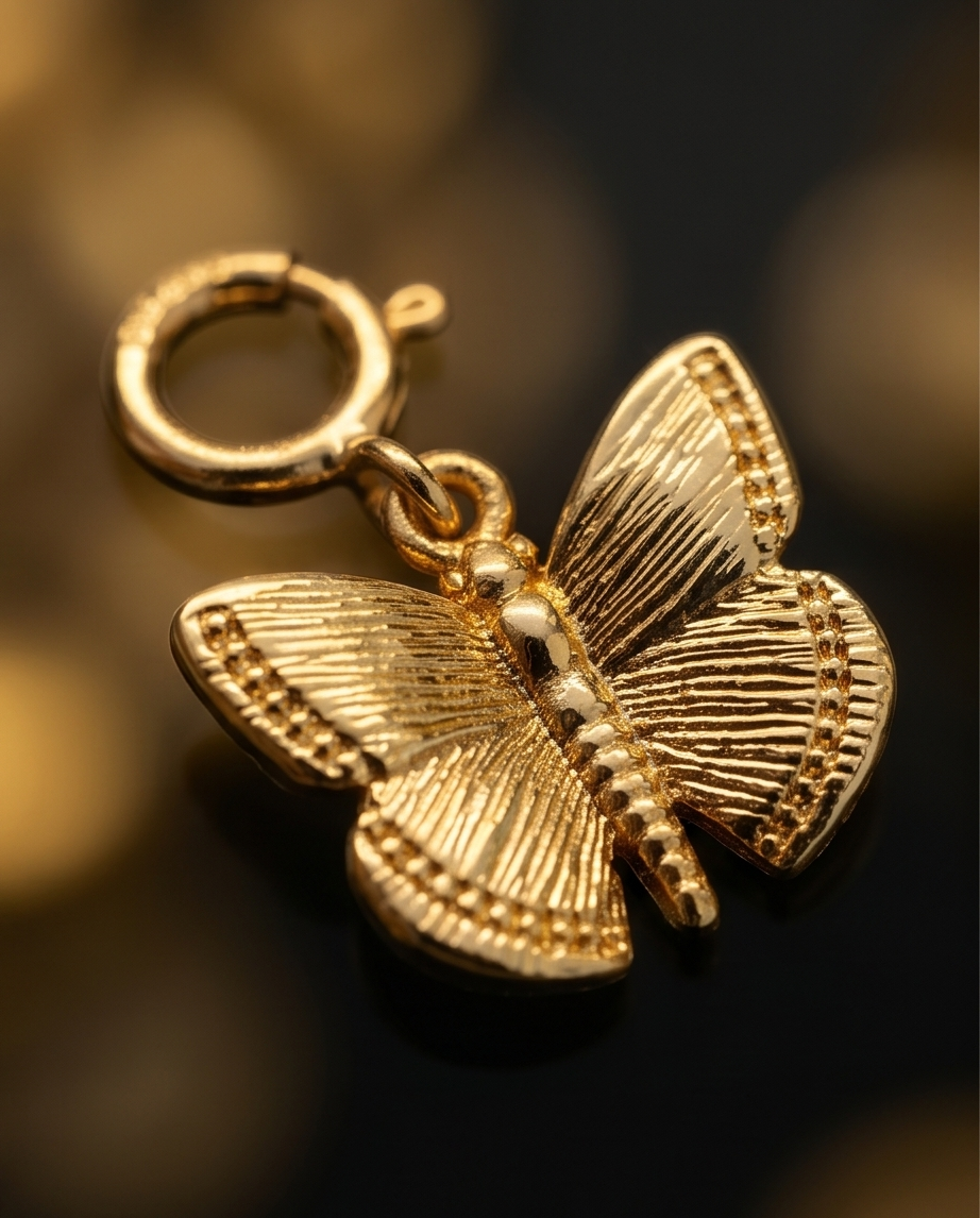 Close up detail of gold filled butterfly charm wing texture and spring clasp — Stacked by Jayneebell