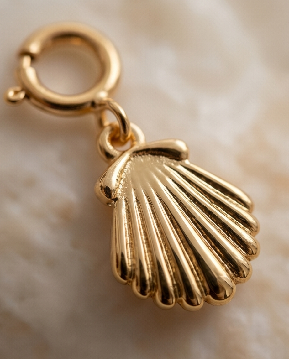 Close up detail of gold filled scallop shell charm ridge texture and spring clasp — Stacked by Jayneebell