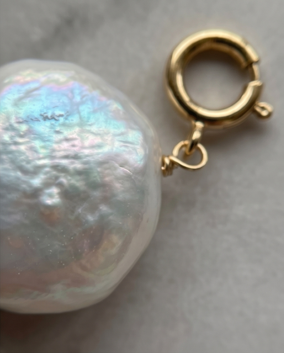 Close up of iridescent freshwater coin pearl with gold filled spring ring clasp — Stacked by Jayneebell