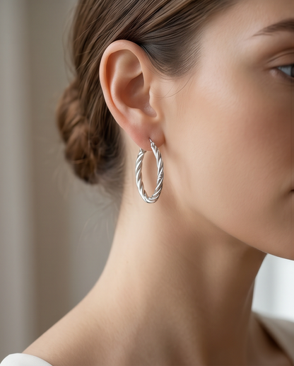 Model wearing The Rope silver twisted hoop earrings, Stacked by Jayneebell