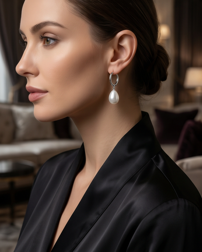 Model wearing The Oyster pearl drop silver huggie hoop earrings, Stacked by Jayneebell