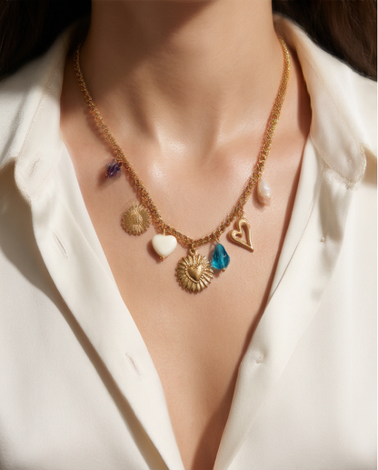 Model wearing Endless Summer gold mixed charm necklace with white silk top, Stacked by Jayneebell