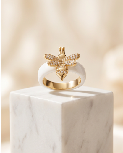 The Queen Bee Ring white ceramic size 8 with gold pavé CZ bee on marble, Stacked by Jayneebell
