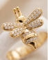 lose-up detail of The Queen Bee Ring gold PVD pavé CZ bee topper on white ceramic band, Stacked by Jayneebell