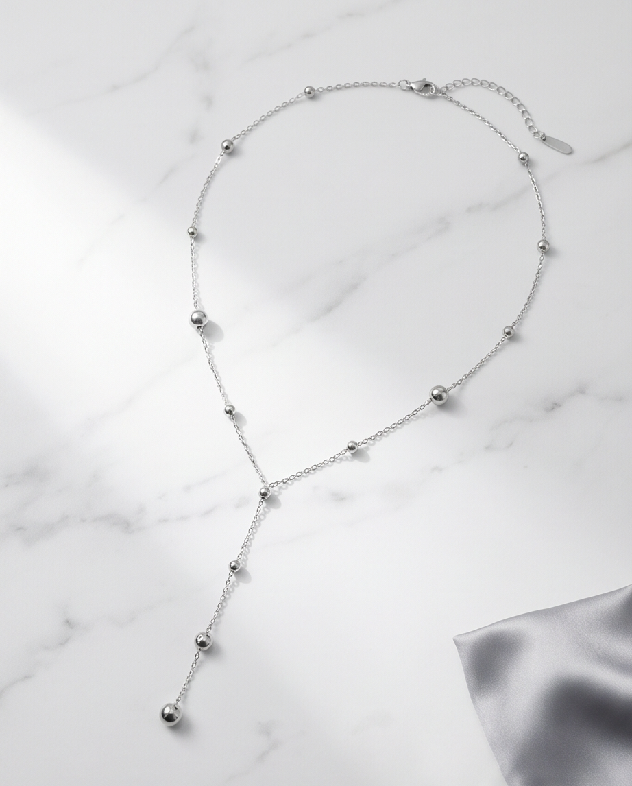 Silver Lining silver PVD satellite chain lariat necklace on marble, Stacked by Jayneebell