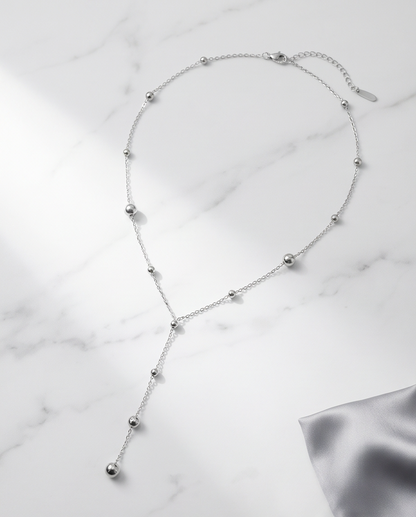 Silver Lining silver PVD satellite chain lariat necklace on marble, Stacked by Jayneebell