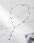 Silver Lining silver PVD satellite chain lariat necklace on marble, Stacked by Jayneebell