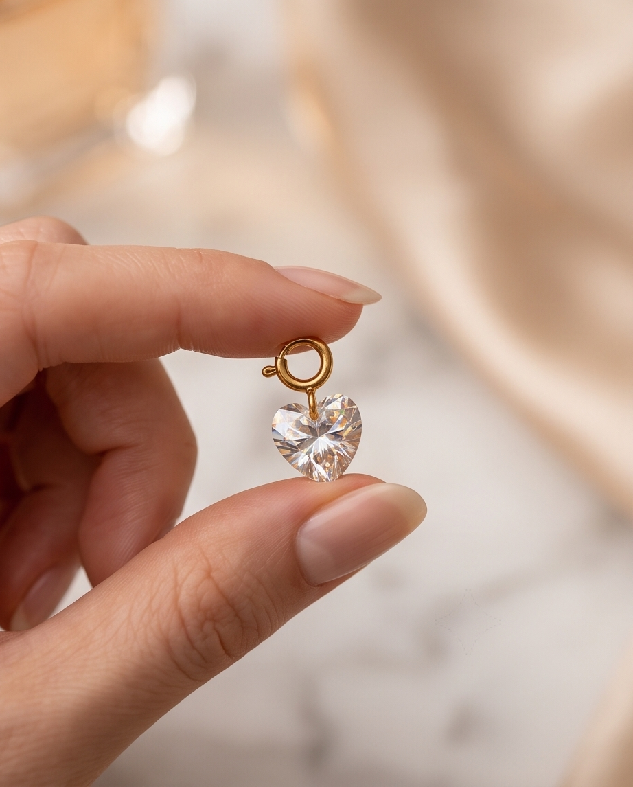 Hand holding Smitten heart-cut charm with gold filled clasp | Stacked by Jayneebell