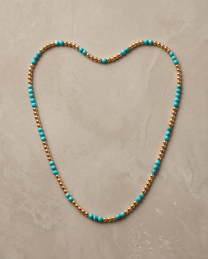 The Sedona Necklace laid in a heart shape, genuine turquoise and 14k gold filled 4mm beaded stretch necklace | Stacked by Jayneebell