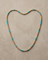 The Sedona Necklace laid in a heart shape, genuine turquoise and 14k gold filled 4mm beaded stretch necklace | Stacked by Jayneebell