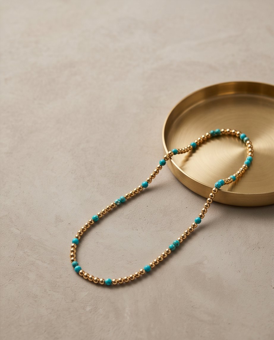 The Sedona Necklace draped over a gold dish, turquoise and 14k gold filled 4mm beaded stretch necklace | Stacked by Jayneebell
