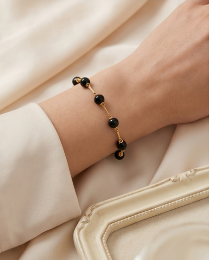 Black opal gold filled station bracelet styled on wrist — Stacked by Jayneebell
