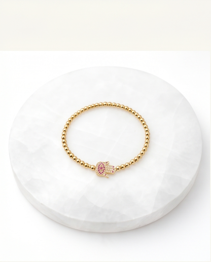 The Hamsa bracelet Rose variant styled flat lay — Stacked by Jayneebell