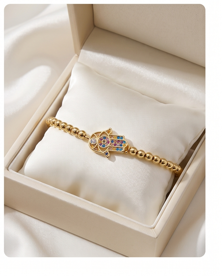 Gold bracelet with a colorful hamsa charm in a jewelry box. Close up of Rainbow Hamsa charm with multicolor CZ stones — Stacked by Jayneebell